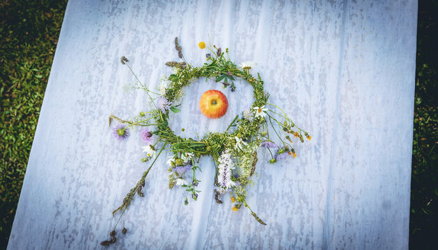Overhead view of handcrafted circular wreath made with meadow flowers.