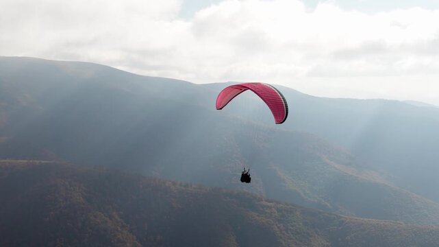 Paragliding active sport against giant mountains in highland
