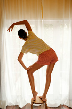 Balancing on Wooden Stool