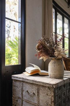 Interior vignette of rustic textured objects and vintage French doors