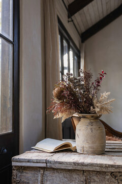Interior vignette of rustic textured objects and vintage French doors