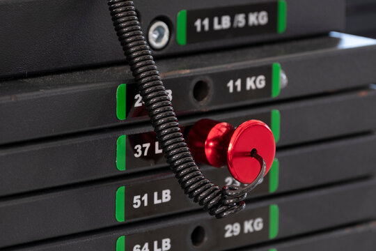 Close-up of weight stack selector mechanism on gym machine