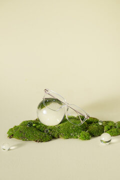 A minimalist composition featuring clear glasses and crystal sphere
