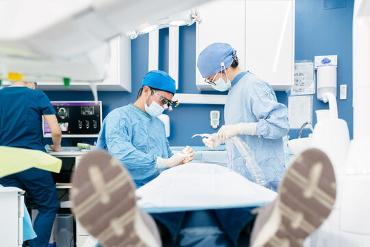 Dental Surgeons Performing Oral Procedure