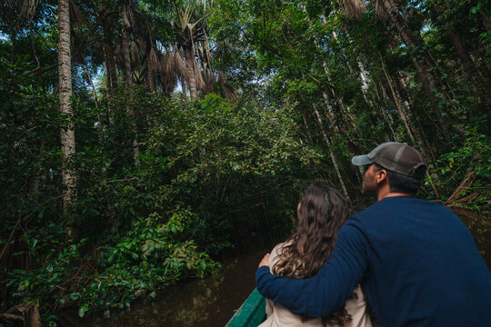 Adventure travel couple in the amazon rainforest jungle