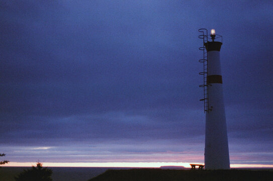 Lighthouse with cloudy sky during sunset, Fundy Bay, Nova Scotia