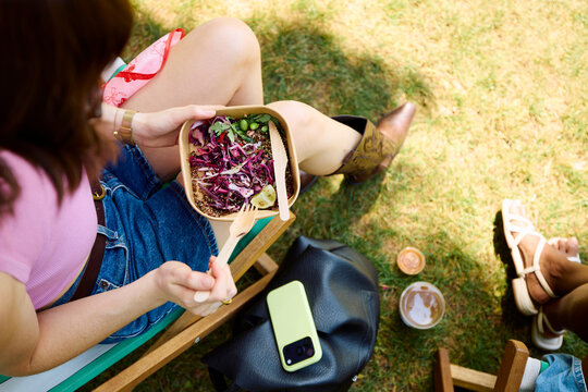 Woman enjos a tekaout meal in the park
