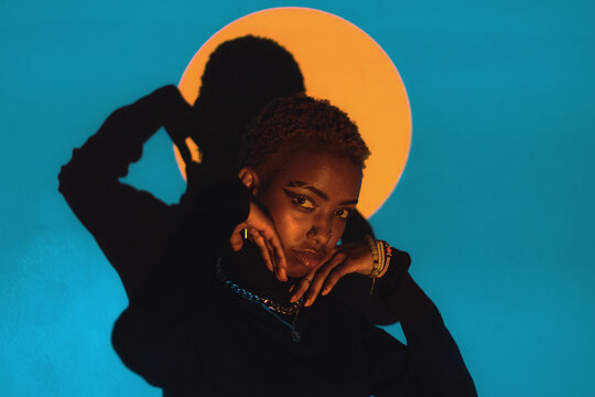 Woman Posing in a Colourful Lighting Setup Indoors