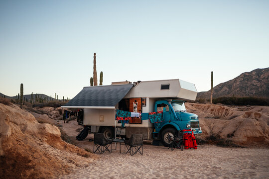 truck camper campsite set up among desert cacti