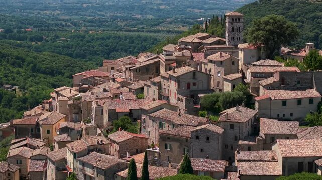 Casperia Sabina Rieti Italy 70mm drone view of medieval hilltop village bell tower. Compressed aerial reveal of historic borgo houses over green hills landscape award town b-roll stock video
