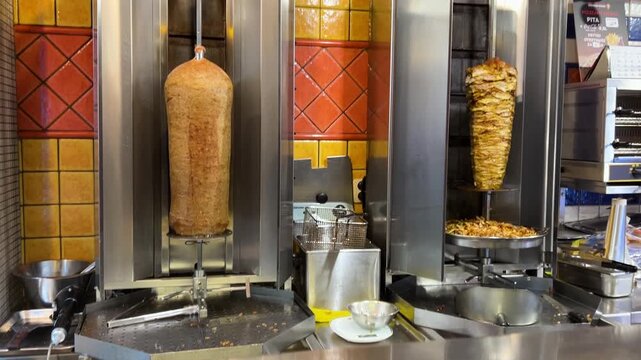 Shawarma, doner kebab. Vertical grill roaster with veal, chicken, and lamb. Grilled meat rotates, how to make shawarma.