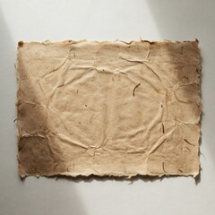 Fototapeta premium Rough textured handmade paper sheet with natural fibers and irregular torn edges casting shadows
