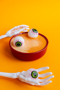 Halloween pumpkin soup with fake eyeballs