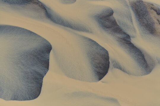 Aerial view of Drangajokull glacier with intricate patterns of snow and ice formations in Holmavik, Strandabyggd, Iceland.