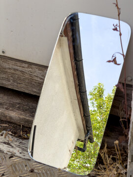 old abandoned building with mirror reflecting the clear blue sky 
