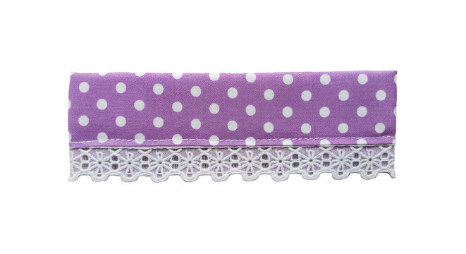 Piece of purple fabric with white polka dot pattern and elegant lace trim on transparent background concept of vintage tailoring and textile craft