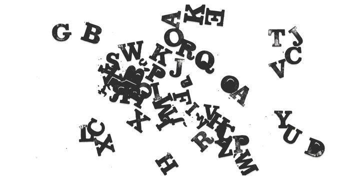 Black alphabet letters scattered randomly on a flat surface