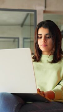 Indian young freelance professional it specialist, coder programmer using pc doing online data analysing. Focused latin hispanic business woman working on laptop computer in coworking office. Vertical