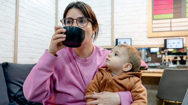 Mother with child enjoying a drink at a restaurant