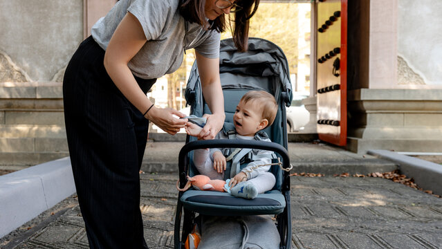 Mother caring for her child outside historical temple