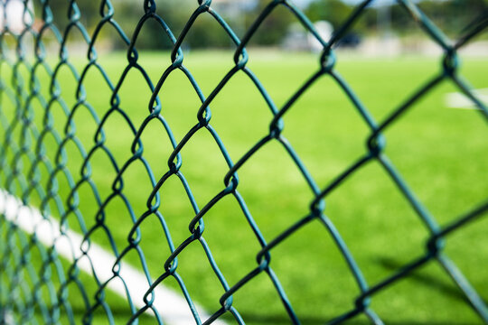 Chain link fence overlooking a green soccer field