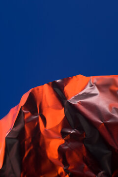 Abstract crumpled foil against blue background