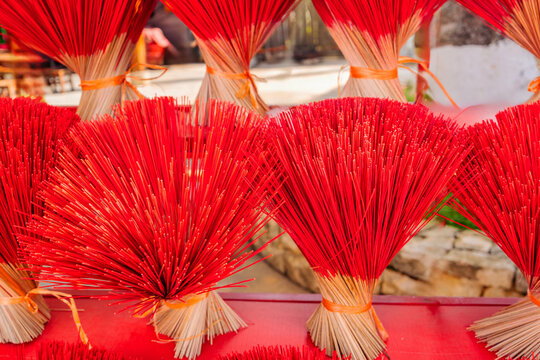 Handmade red incense bundles drying at Vietnamese village