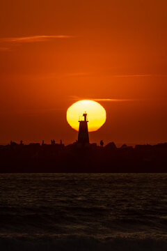 Sunset silhouette of lighthouse at Vila do Conde, Portugal