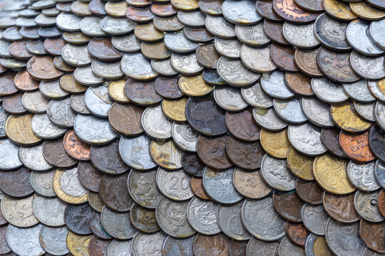 Arrangement of vintage coins creating textured pattern