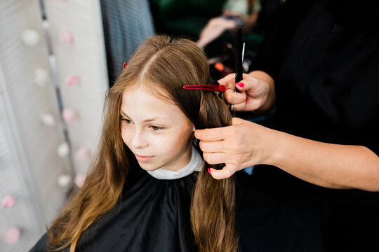 Teen at hair salon getting stylish haircut