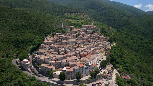 Roccantica Italy 4K Drone. Forward fly through medieval borgo center between watchtower and castle fortress. Cinematic narrow gap aerial reveal of green hills valley video asset