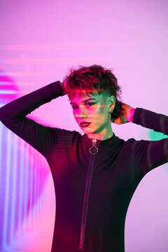 Cyberpunk young woman in neon glitch light studio portrait