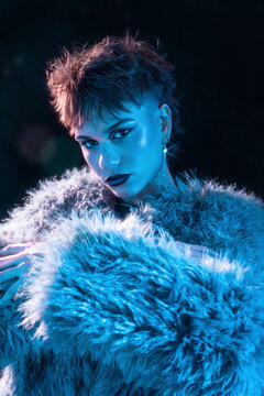 Cyberpunk young woman portrait in neon blue studio light