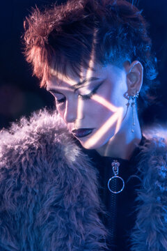 Cyberpunk young woman portrait with neon light and fur