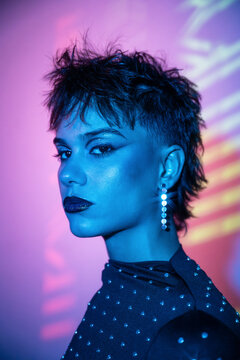 Cyberpunk young woman portrait in neon blue and purple