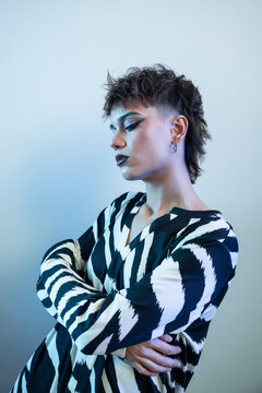 Edgy young woman fashion model in zebra print pose