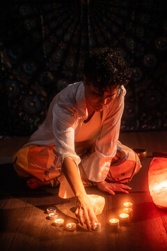 Latin woman arranging tea lights for a spiritual ritual