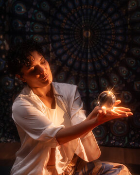 Esoteric Latin woman holding glowing crystal ball scene