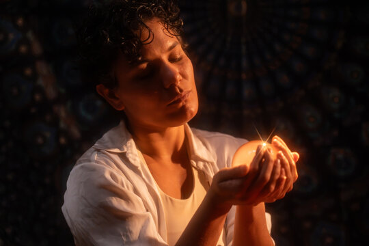 Spiritual Latin woman holding crystal ball at night