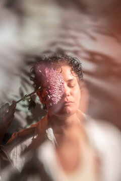 Spiritual Latin woman meditating with flower portrait