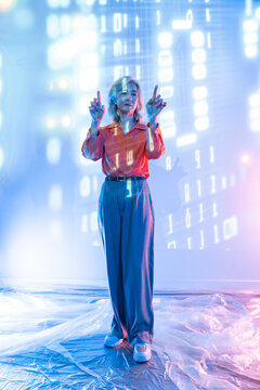 Futuristic senior Asian woman using hologram interface