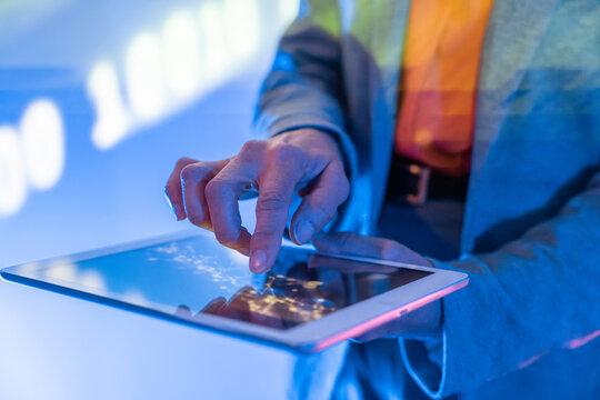 Hand of old woman using tablet touch screen