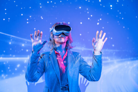 Futuristic senior Asian woman using VR headset in neon space