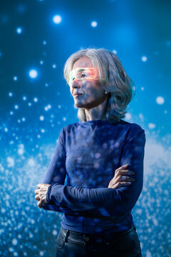 Futuristic senior Asian woman with holographic visor portrait