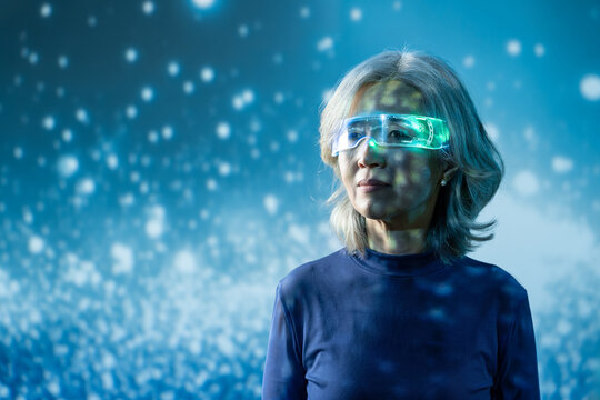 Futuristic senior Asian woman with AR visor in blue light