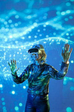 Futuristic senior Asian woman using VR in digital space
