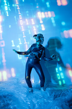 Senior Asian woman using VR in futuristic data light