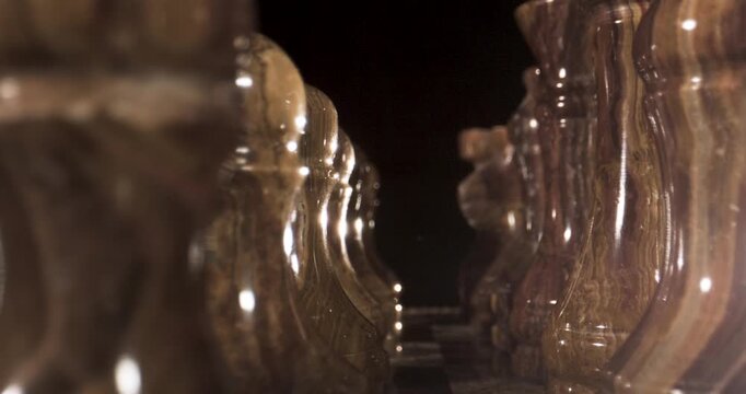 Intricate Close-Up of an Ornate Chess Set in a Dimly Lit Environment
