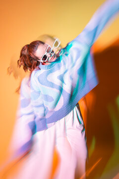 Young woman dancer in trippy lens and neon light blur