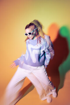 Young woman dancer in trippy lens effect with neon light